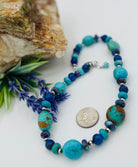 Necklace featuring Kingman turquoise with gold matrix, purple Mojave turquoise, lapis, and sterling silver Navajo pearl beads. U.S. quarter for size reference. Available only from Rockstar Cowgirl online or in store in Cody, Wyoming.
