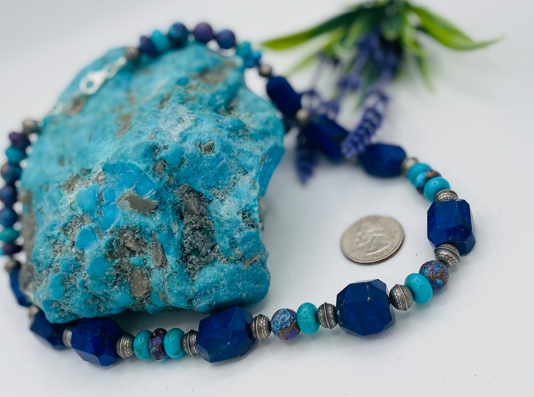 Beaded necklace featuring Lapis lazuli, royal beauty turquoise, purple Mojave turquoise, sterling silver beads and a sterling silver clasp. U.S. quarter for size reference. Available only from Rockstar Cowgirl online or in store in Cody, Wyoming.