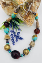 Chunky necklace featuring Baltic amber, Kingman turquoise, African bronze beads, large deer antler beads, and sterling silver Navajo pearl beads. Available only from Rockstar Cowgirl online or in store in Cody, Wyoming.