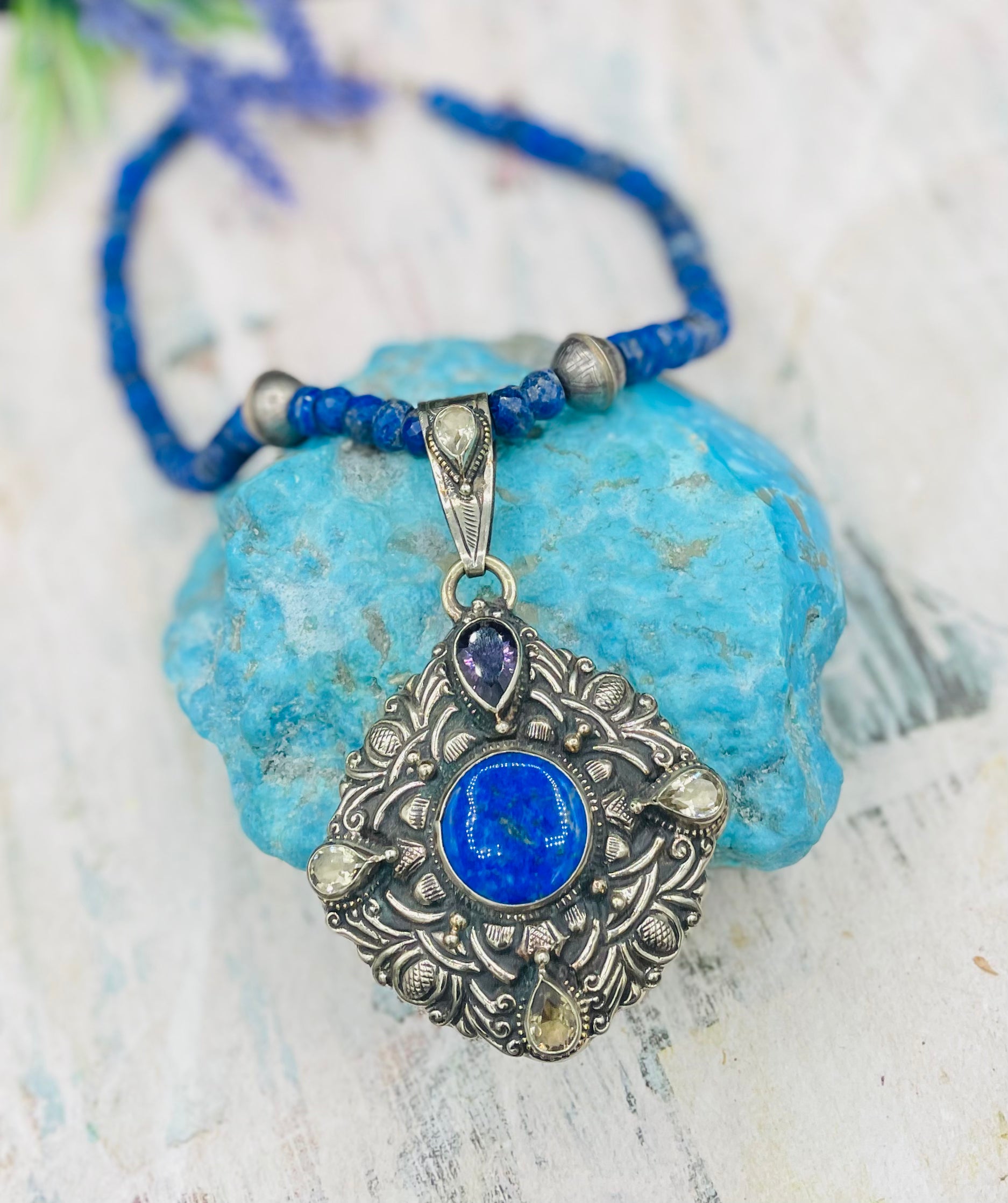 Lapis necklace with stamped sterling silver beads and a Bali silver pendent featuring lapis, lemon quartz, and amethyst. Available only from Rockstar Cowgirl online or in store in  
Cody, Wyoming.  