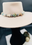 #8 turquoise, knobby deer antler, and sterling silver hatband finished with deer lace and slide bead for fit. Available only from Rockstar Cowgirl online or in store in Cody, Wyoming.