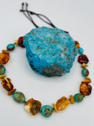 Adjustable beaded hatband featuring Kingman turquoise, Baltic amber, and sterling silver Navajo pearl beads and finished with deer leather and a silicone slide bead. Available only from Rockstar Cowgirl online or in store in Cody, Wyoming.