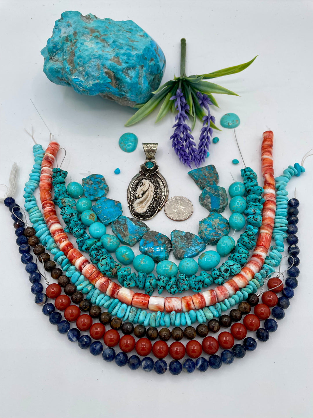 Bead box featuring Kingman turquoise, Sonoran turquoise, sodalite, spiney oyster, red jasper, bronzite, and a bone horse pendent. U.S. quarter for size reference. Available only from Rockstar Cowgirl online or in store in Cody, Wyoming.