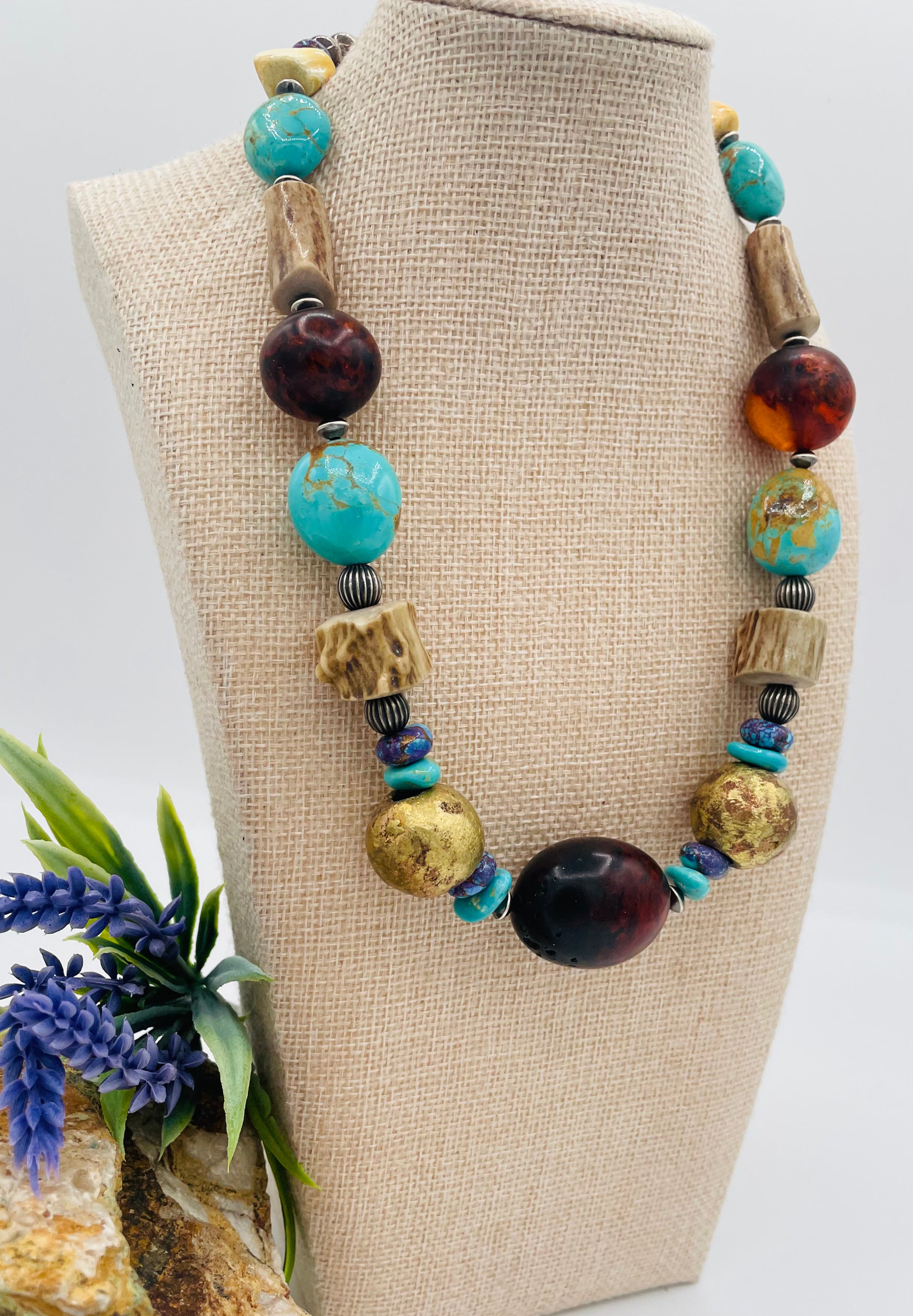 Chunky necklace featuring Baltic amber, Kingman turquoise, African bronze beads, large deer antler beads, and sterling silver Navajo pearl beads. Available only from Rockstar Cowgirl online or in store in Cody, Wyoming.