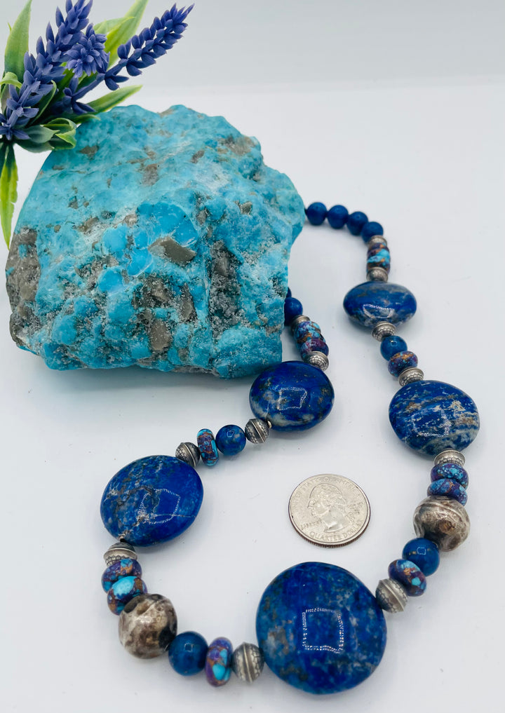 Beaded necklace featuring Lapis, purple Mojave turquoise, sterling silver beads, and a sterling silver lobster clasp with extender chain. U.S. quarter for size reference. Available only from Rockstar Cowgirl online or in store in Cody, Wyoming.