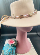 Hatband or necklace with giant baroque natural luster pearls, knobby deer antler beads, and  sterling silver beads and finished with feathers, deer lace, and a slide bead. Available only from Rockstar Cowgirl online or in store in Cody, Wyoming.