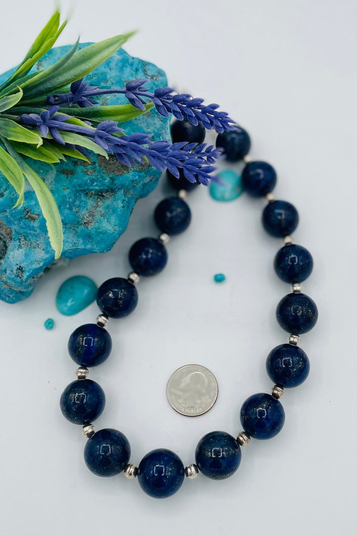 Beaded necklace featuring large Afghan lapis round beads with sterling silver beads between. U.S. quarter for size reference. Available only from Rockstar Cowgirl online or in store in Cody, Wyoming.