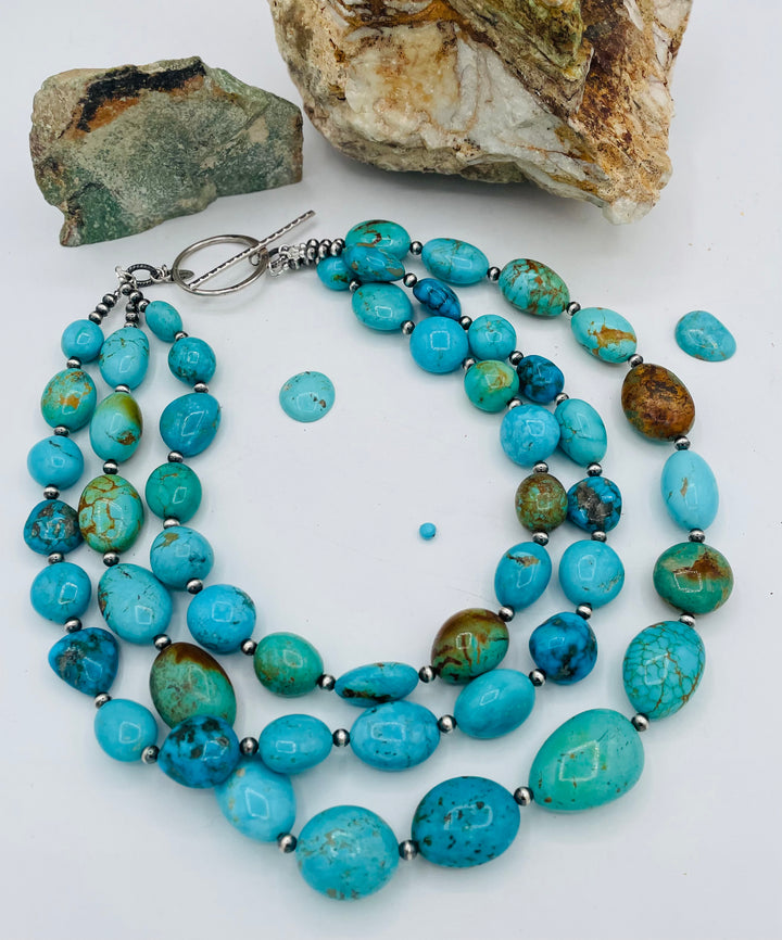 3 strand beaded necklace featuring Kingman turquoise in blues and greens with sterling silver Navajo pearl beads. Available only from Rockstar Cowgirl online or in store in Cody, Wyoming.