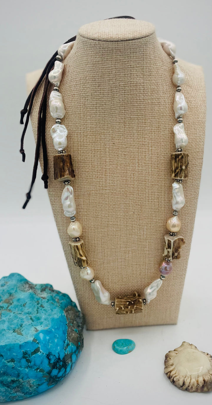 Adjustable beaded hattband featuring white flameball baroque pearls, textured deer antler, sterling silver beads, and finished with deer lace in the back. Available only from Rockstar Cowgirl online or in store in Cody, Wyoming.