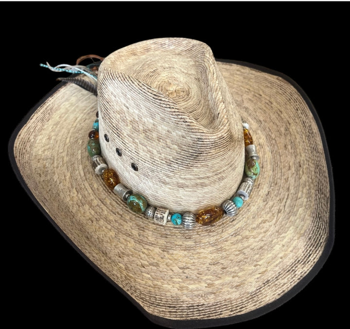 Hatband featuring Kingman turquoise, Baltic amber, deer antler, and Hill tribe sterling sliver beads. Finished in the back with feathers, deer lace, and a sliding bead. Available only from Rockstar Cowgirl online or in store in Cody, Wyoming.