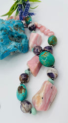 Chunky necklace featuring pink Peruvian opal nuggets, Kingman turquoise, cape amethyst, amazonite, and sterling silver Navajo pearl beads. Available only from Rockstar Cowgirl online or in store in Cody, Wyoming.