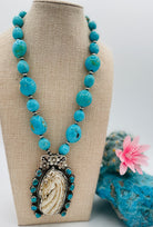 Necklace featuring Kingman turquoise nuggets, sterling silver beads, and carved bone pendent. Available only from Rockstar Cowgirl online or in store in Cody, Wyoming.