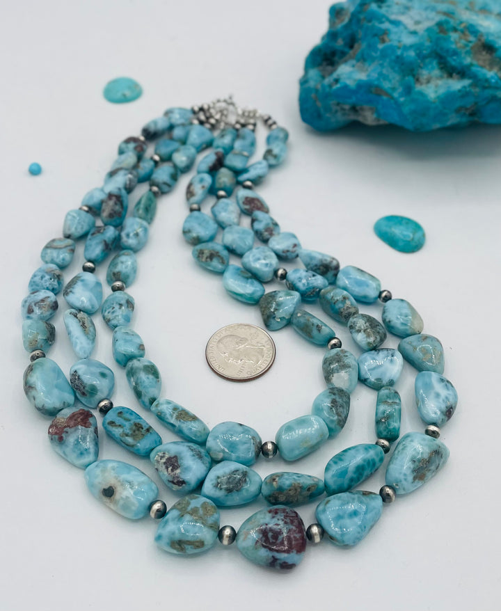 Beaded 3 strand necklace featuring smooth larimar nuggets and sterling silver beads. U.S. quarter for size reference. Available only from Rockstar Cowgirl online or in store in Cody, Wyoming.
