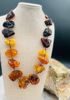 Large slabs of Baltic amber silk knotted with bronze sprinkled through out and bronze hook clasp.  Available only from Rockstar Cowgirl online or in store in Cody, Wyoming.