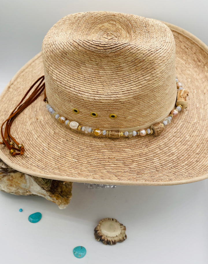 Adjustable beaded hatband featuring blue lace agate, aquamarine, glass crystals, gold details, baroque natural luster pearls, deer antler beads, and finished with deer lace in the back. Available only from Rockstar Cowgirl online or in store in Cody, Wyoming.