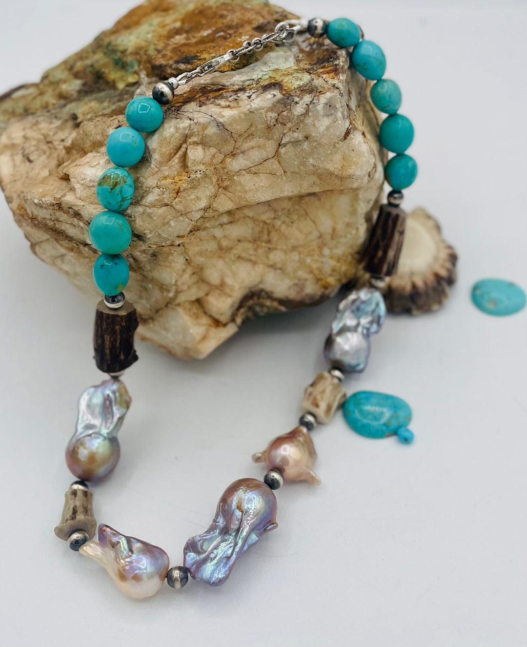 Beaded necklace featuring Flame ball natural luster baroque pearls, deer antler, Kingman turquoise nuggets, and sterling silver beads. Available only from Rockstar Cowgirl online or in store in Cody, Wyoming.