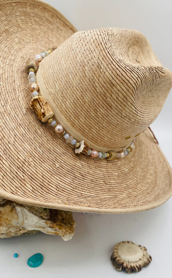 Adjustable beaded hatband featuring blue lace agate, aquamarine, glass crystals, gold details, baroque natural luster pearls, deer antler beads, and finished with deer lace in the back. Available only from Rockstar Cowgirl online or in store in Cody, Wyoming.