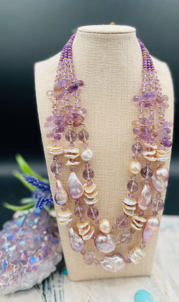 Decadent 3 strand necklace set with matching earrings. Featuring giant flameball natural luster pearls, giant Edison natural luster pearls, pearl discs, pink amethyst, ametrine, and phosphosiderite. Available only from Rockstar Cowgirl online or in store in Cody, Wyoming.