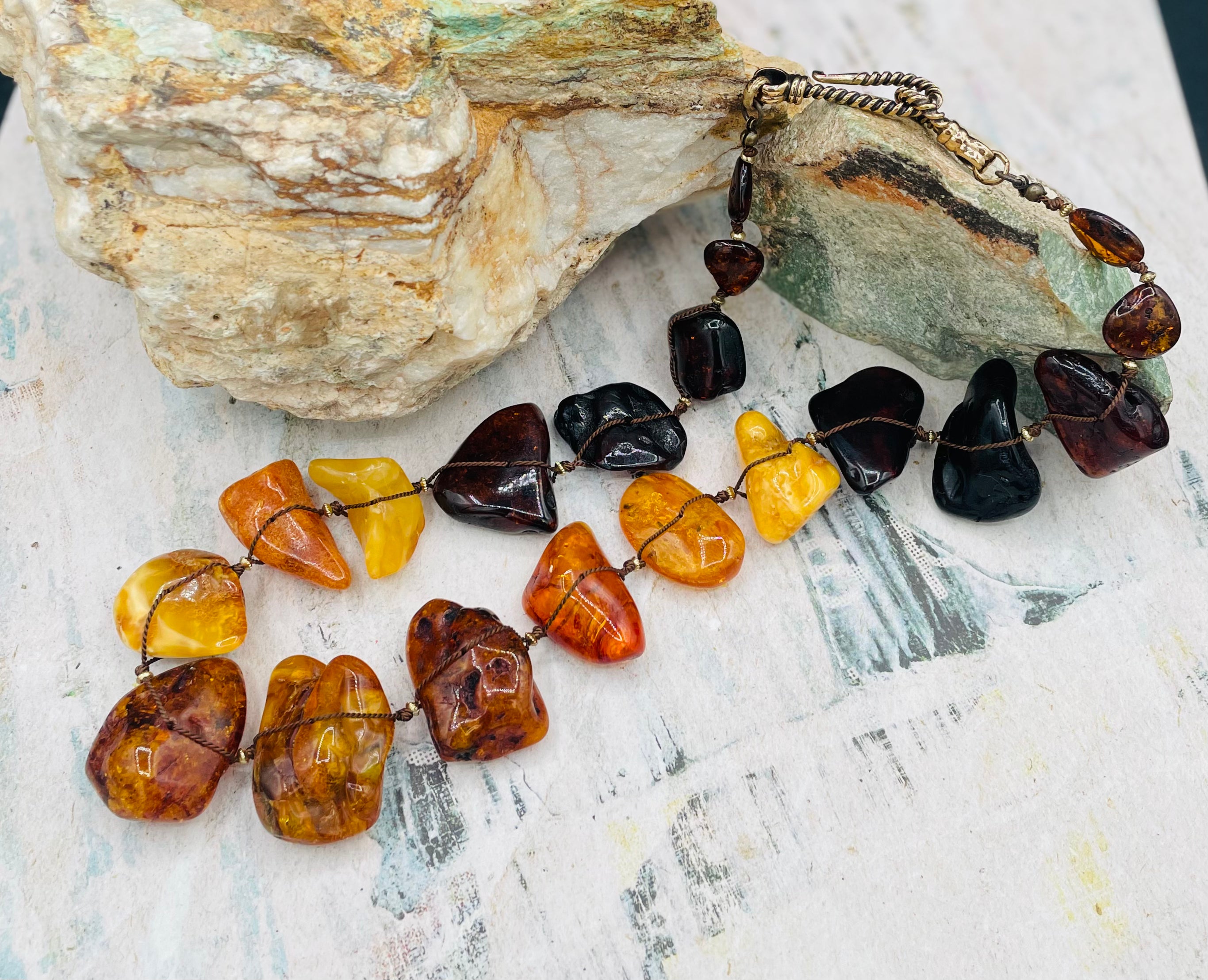 Large slabs of Baltic amber silk knotted with bronze sprinkled through out and bronze hook clasp.  Available only from Rockstar Cowgirl online or in store in Cody, Wyoming.