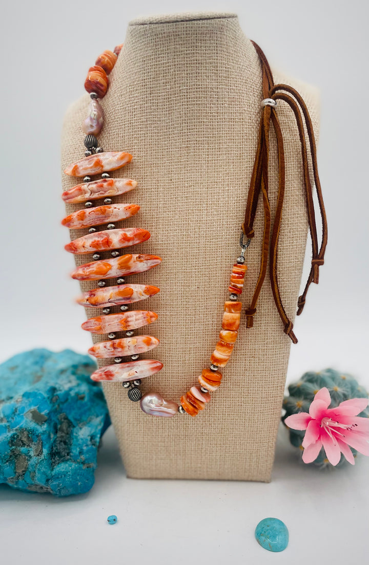 Adjustable beaded hatband featuring spiney oyster, natural luster flameball pearls, sterling silver beads, and finished with deer lace in the back. Available only from Rockstar Cowgirl online or in store in Cody, Wyoming.