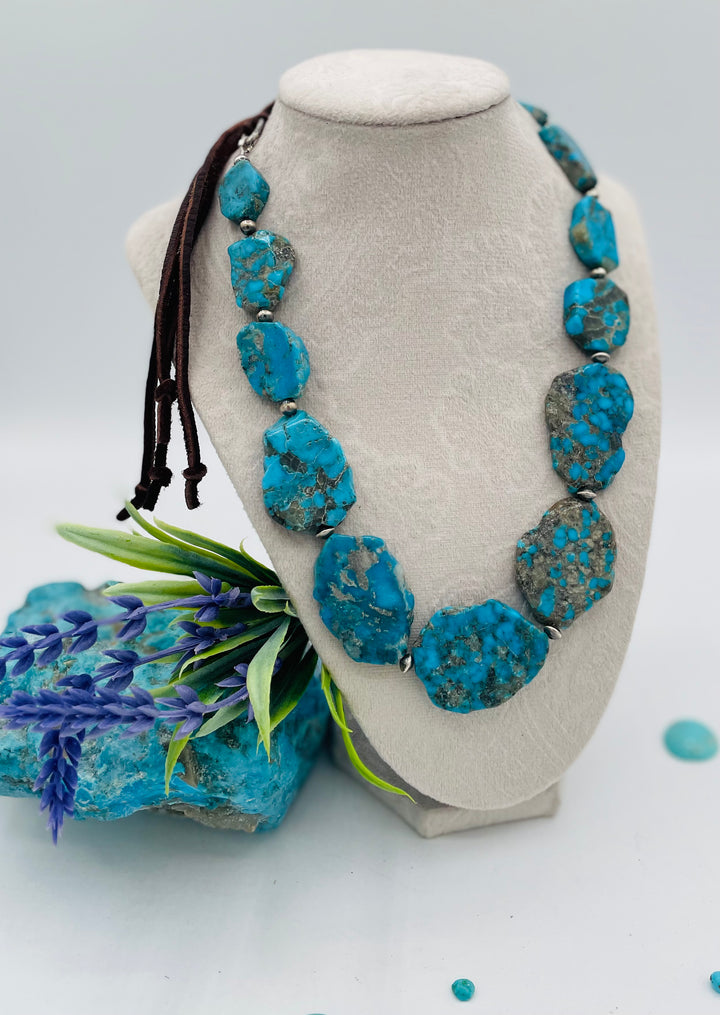 Beaded adjustable hatband that doubles as a necklace featuring Ithaca Peak turquoise and sterling silver Navajo pearl beads with deer lace in the back. Available only from Rockstar Cowgirl online or in store in Cody, Wyoming. 