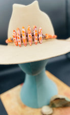 Hatband or necklace featuring several shapes of spiny oyster beads and copper accents. Finished with deer lace each with a charm and a slide bead for fit. Available only from Rockstar Cowgirl online or in store in Cody, Wyoming.