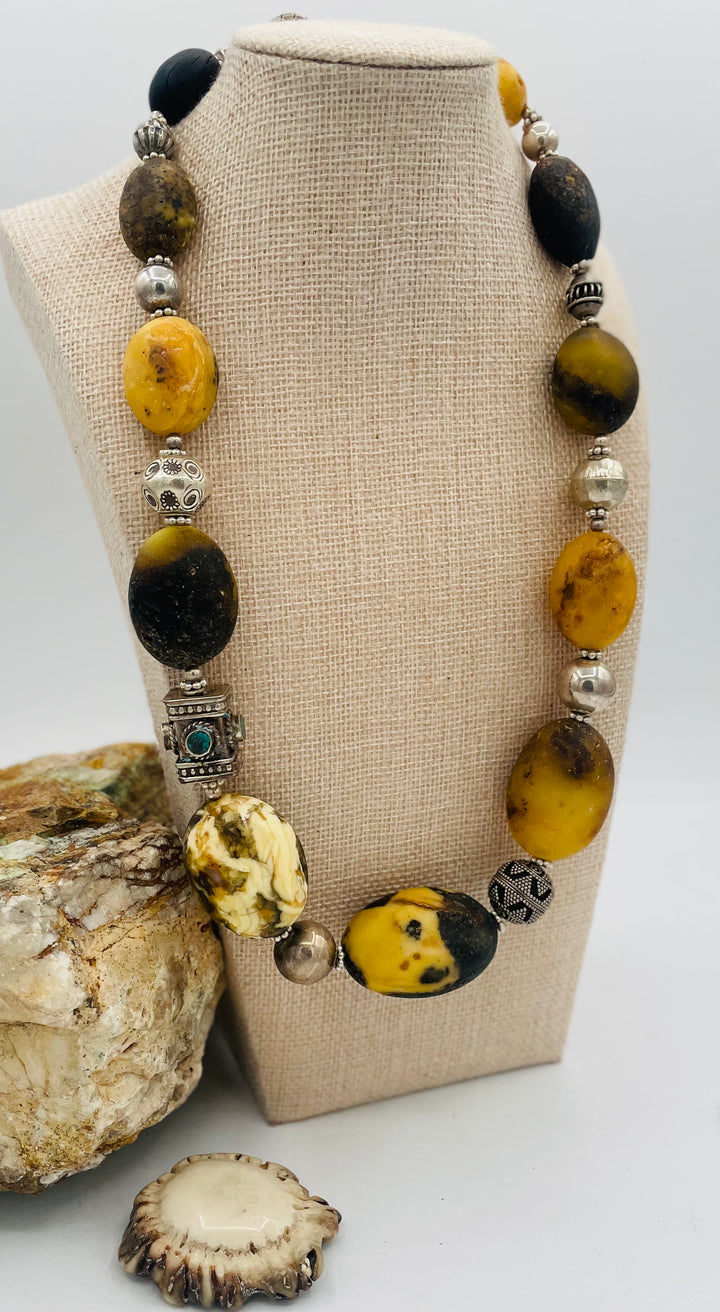 Chunky beaded necklace featuring Baltic amber, repousse beads with turquoise inlay, and sterling silver beads. Available only from Rockstar Cowgirl online or in store in Cody, Wyoming.