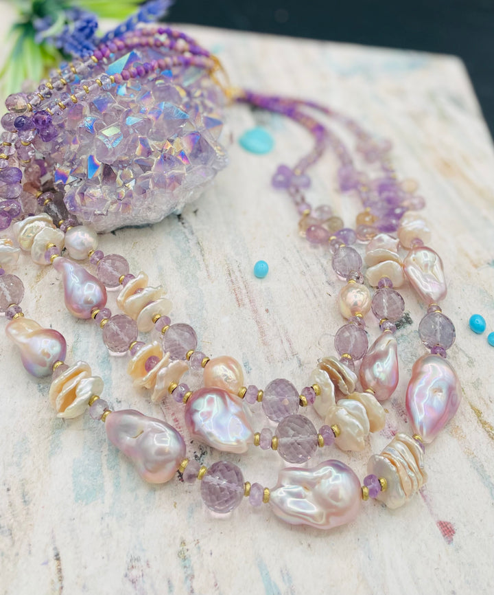 Decadent 3 strand necklace set with matching earrings. Featuring giant flameball natural luster pearls, giant Edison natural luster pearls, pearl discs, pink amethyst, ametrine, and phosphosiderite. Available only from Rockstar Cowgirl online or in store in Cody, Wyoming.