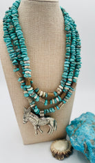 3 strand necklace featuring Campitos turquoise, chrysoprase, and deer antler beads with a donkey pendent. Available only from Rockstar Cowgirl online or in store in Cody, Wyoming.