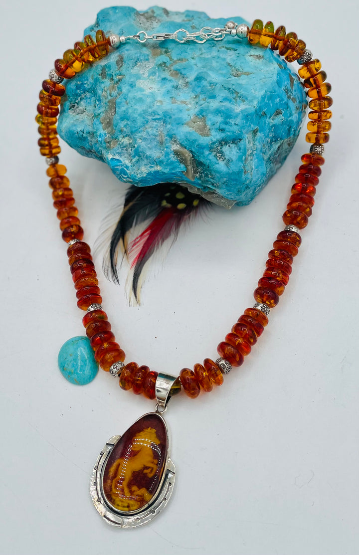 Beaded Baltic amber and sterling silver necklace featuring a Baltic amber and sterling silver pendent with a carved horse reverse cameo. Available only from Rockstar Cowgirl online or in store in Cody, Wyoming.