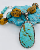 Necklace featuring Kingman turquoise, #8 turquoise, yellow and black Baltic Amber, and sterling silver beads with a Kingman turquoise and sterling silver pendent. Available only from Rockstar Cowgirl online or in store in Cody, Wyoming.