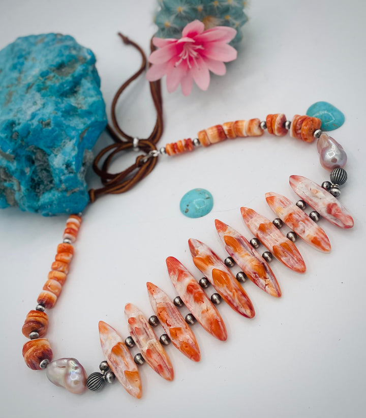 Adjustable beaded hatband featuring spiney oyster, natural luster flameball pearls, sterling silver beads, and finished with deer lace in the back. Available only from Rockstar Cowgirl online or in store in Cody, Wyoming.