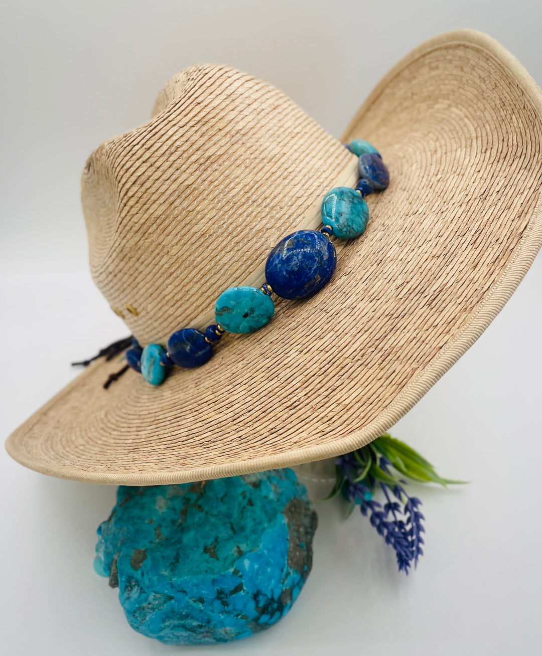 Adjustable beaded hatband featuring lapis nuggets, Kingman turquoise nuggets, African brass details, and finished with deer lace in the back. Available only from Rockstar Cowgirl online or in store in Cody, Wyoming.