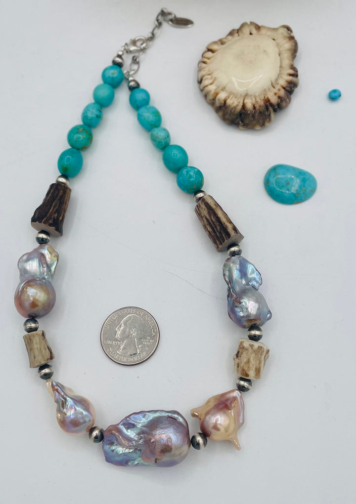 Beaded necklace featuring Flame ball natural luster baroque pearls, deer antler, Kingman turquoise nuggets, and sterling silver beads. U.S. quarter for size reference. Available only from Rockstar Cowgirl online or in store in Cody, Wyoming.