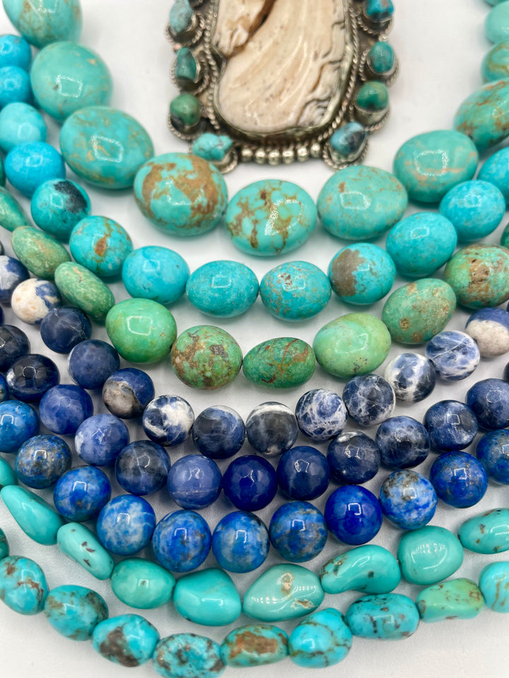 Bead box featuring Kingman turquoise nuggets in 3 colors, sodalite calcite, sodalite, denim lapis, Hubei turquoise, and carved bone horse and turquoise pendent. U.S. quarter for size reference. Available only from Rockstar Cowgirl online or in store in Cody, Wyoming.