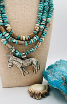 3 strand necklace featuring Campitos turquoise, chrysoprase, and deer antler beads with a donkey pendent. Available only from Rockstar Cowgirl online or in store in Cody, Wyoming.