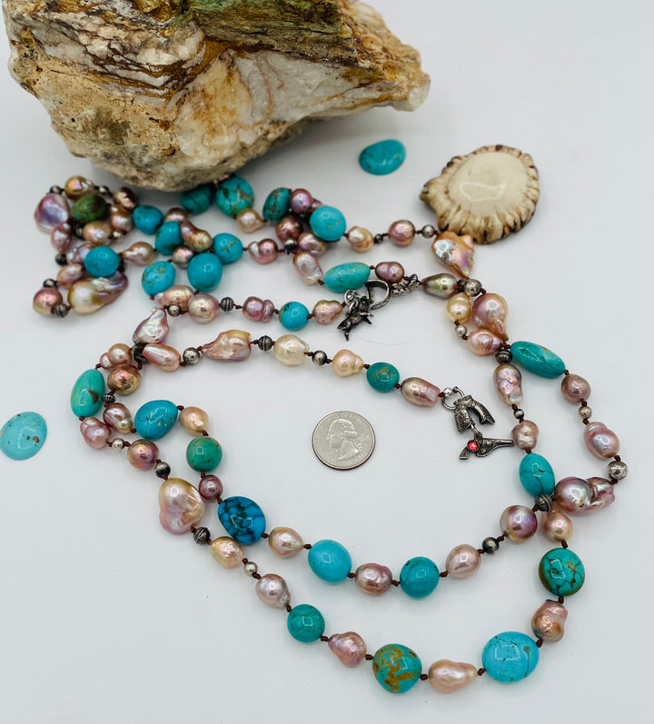 Silk knotted lariat necklace featuring baroque natural luster pearls, Kingman turquoise nuggets, and sterling silver beads. U.S. quarter for size reference. Available only from Rockstar Cowgirl online or in store in Cody, Wyoming.