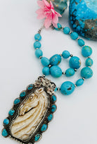 Necklace featuring Kingman turquoise nuggets, sterling silver beads, and carved bone pendent. Available only from Rockstar Cowgirl online or in store in Cody, Wyoming.