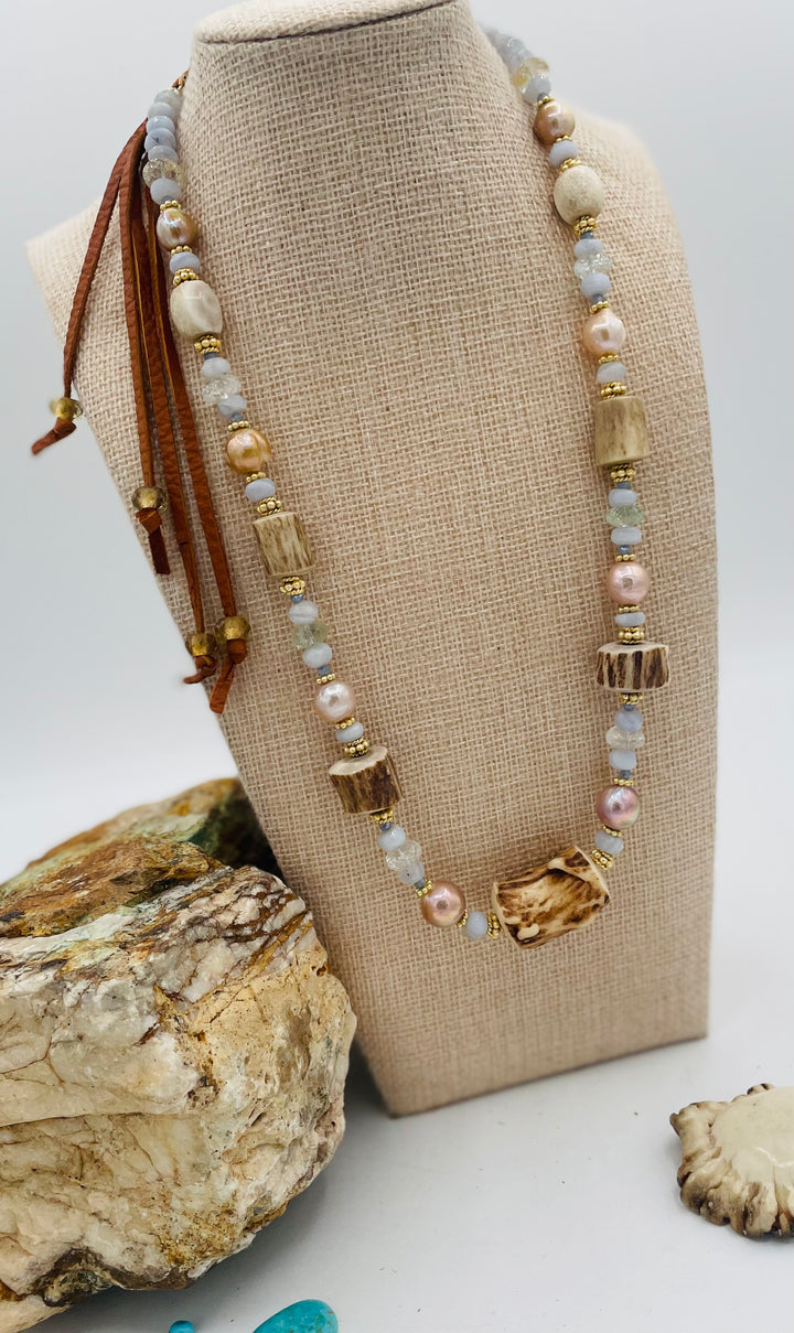 Adjustable beaded hatband featuring blue lace agate, aquamarine, glass crystals, gold details, baroque natural luster pearls, deer antler beads, and finished with deer lace in the back. Available only from Rockstar Cowgirl online or in store in Cody, Wyoming.