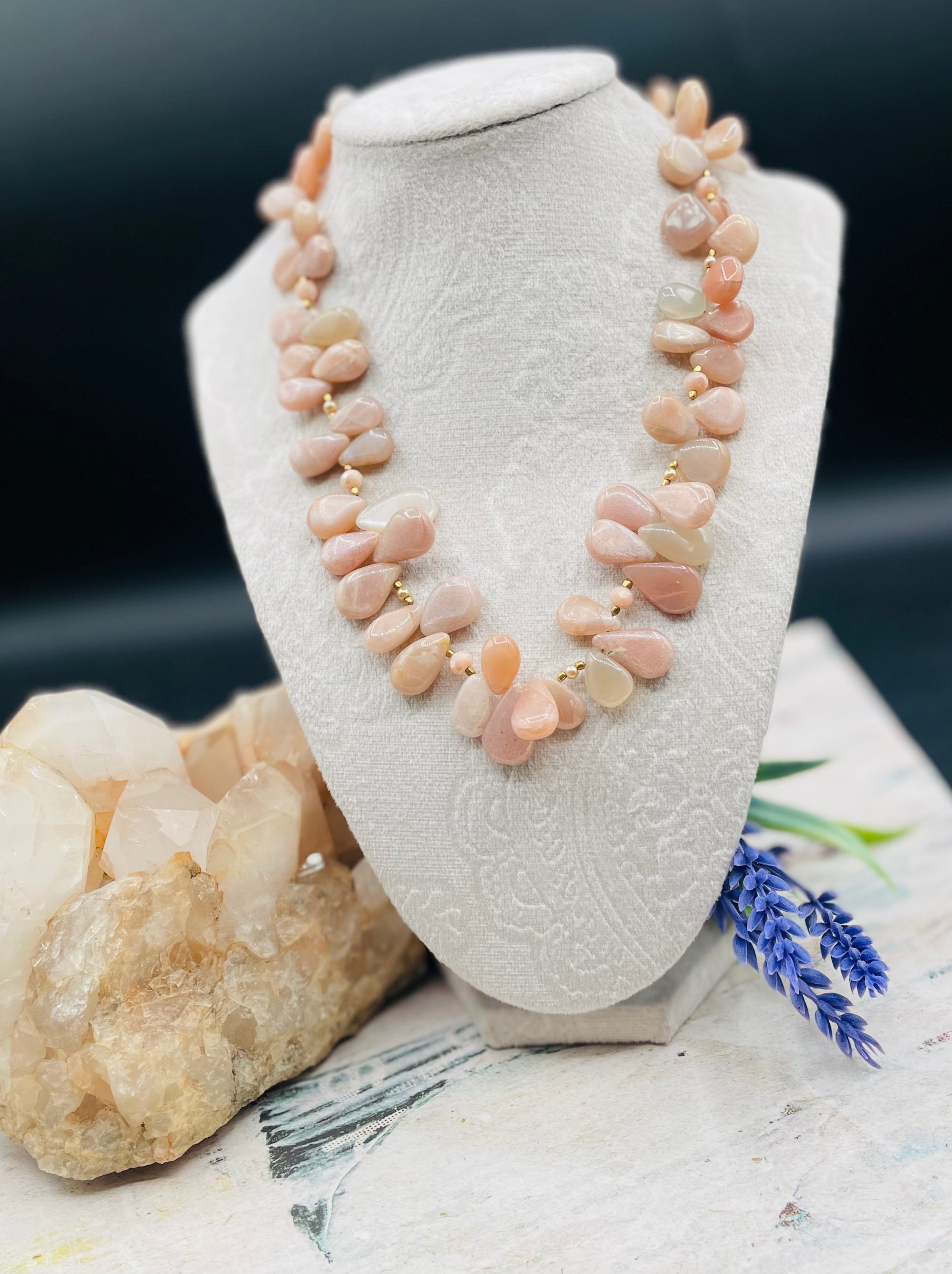 Creamy sunstone hatband or necklace with glass pearls, mauve crystals, and bronze sprinkled throughout finished with gold painted feathers, deer lace and slide bead for fit. Available only from Rockstar Cowgirl online or in store in Cody, Wyoming.