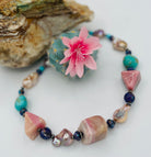 Chunky necklace featuring giant pink Peruvian opal nuggets, AAA grade natural luster baroque pearls, purple Mojave turquoise, and sterling silver Navajo pearl beads. Available only from Rockstar Cowgirl online or in store in Cody, Wyoming.