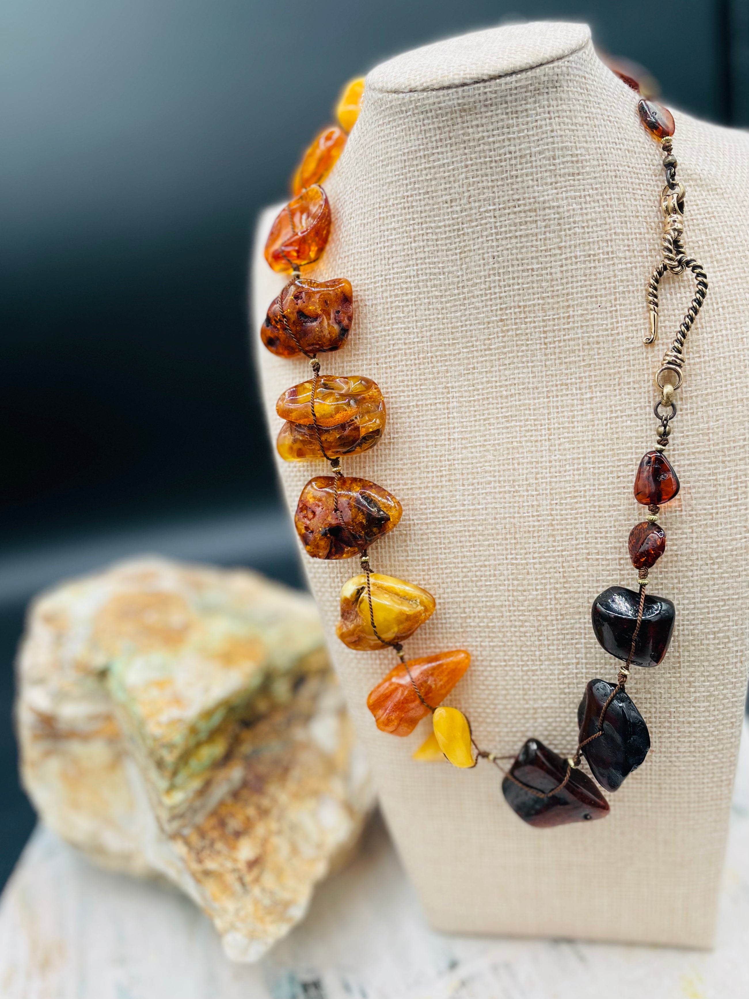 Large slabs of Baltic amber silk knotted with bronze sprinkled through out and bronze hook clasp.  Available only from Rockstar Cowgirl online or in store in Cody, Wyoming.