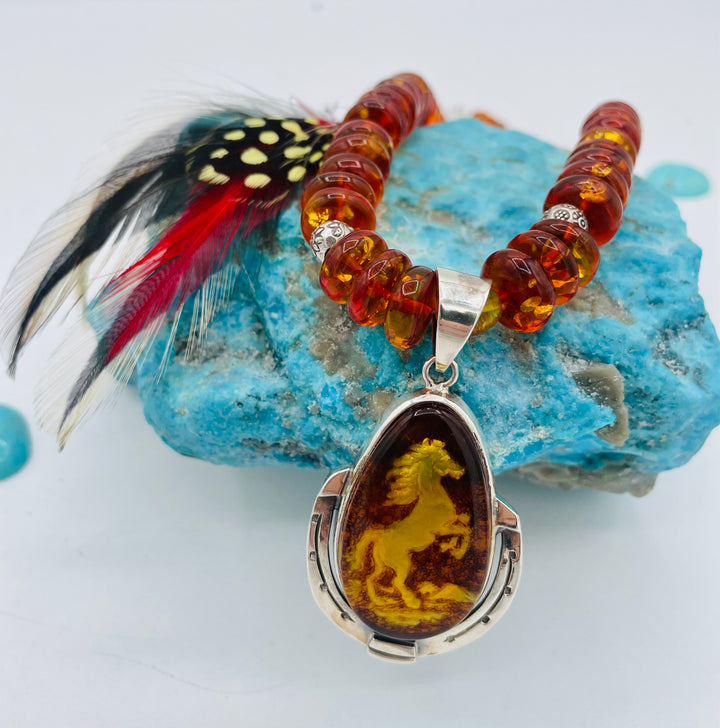 Beaded Baltic amber and sterling silver necklace featuring a Baltic amber and sterling silver pendent with a carved horse reverse cameo. Available only from Rockstar Cowgirl online or in store in Cody, Wyoming.