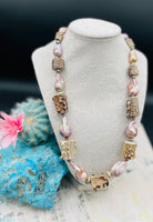 Hatband or necklace with giant baroque natural luster pearls, knobby deer antler beads, and  sterling silver beads and finished with feathers, deer lace, and a slide bead. Available only from Rockstar Cowgirl online or in store in Cody, Wyoming.