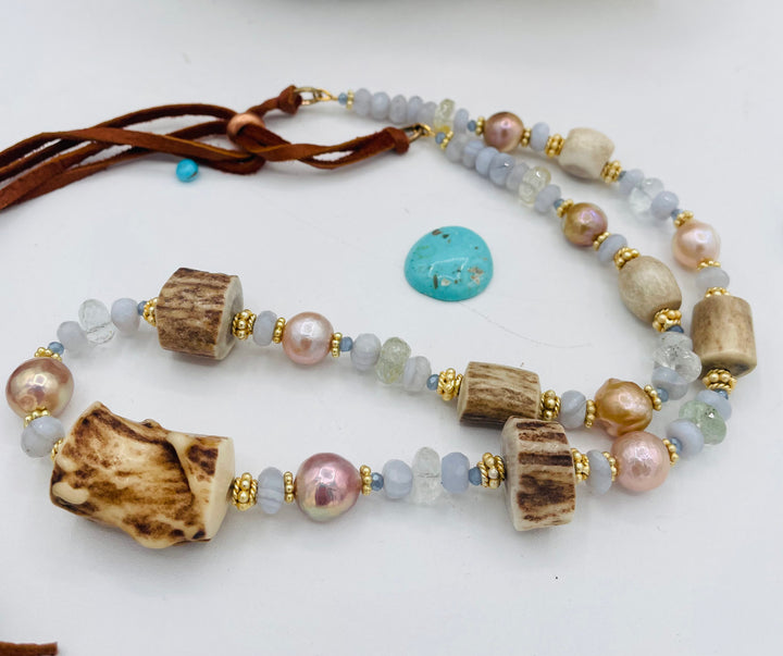 Adjustable beaded hatband featuring blue lace agate, aquamarine, glass crystals, gold details, baroque natural luster pearls, deer antler beads, and finished with deer lace in the back. Available only from Rockstar Cowgirl online or in store in Cody, Wyoming.