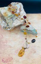 Baltic amber beads wire wrapped into vermeil chain with an amber pendant hanging from a bronze leaf toggle 