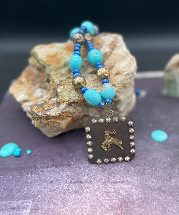 Close up of the large concho pendent on this Kingman turquoise and lapis necklace. Available from Rockstar Cowgirl online or in store in Cody, Wyoming.