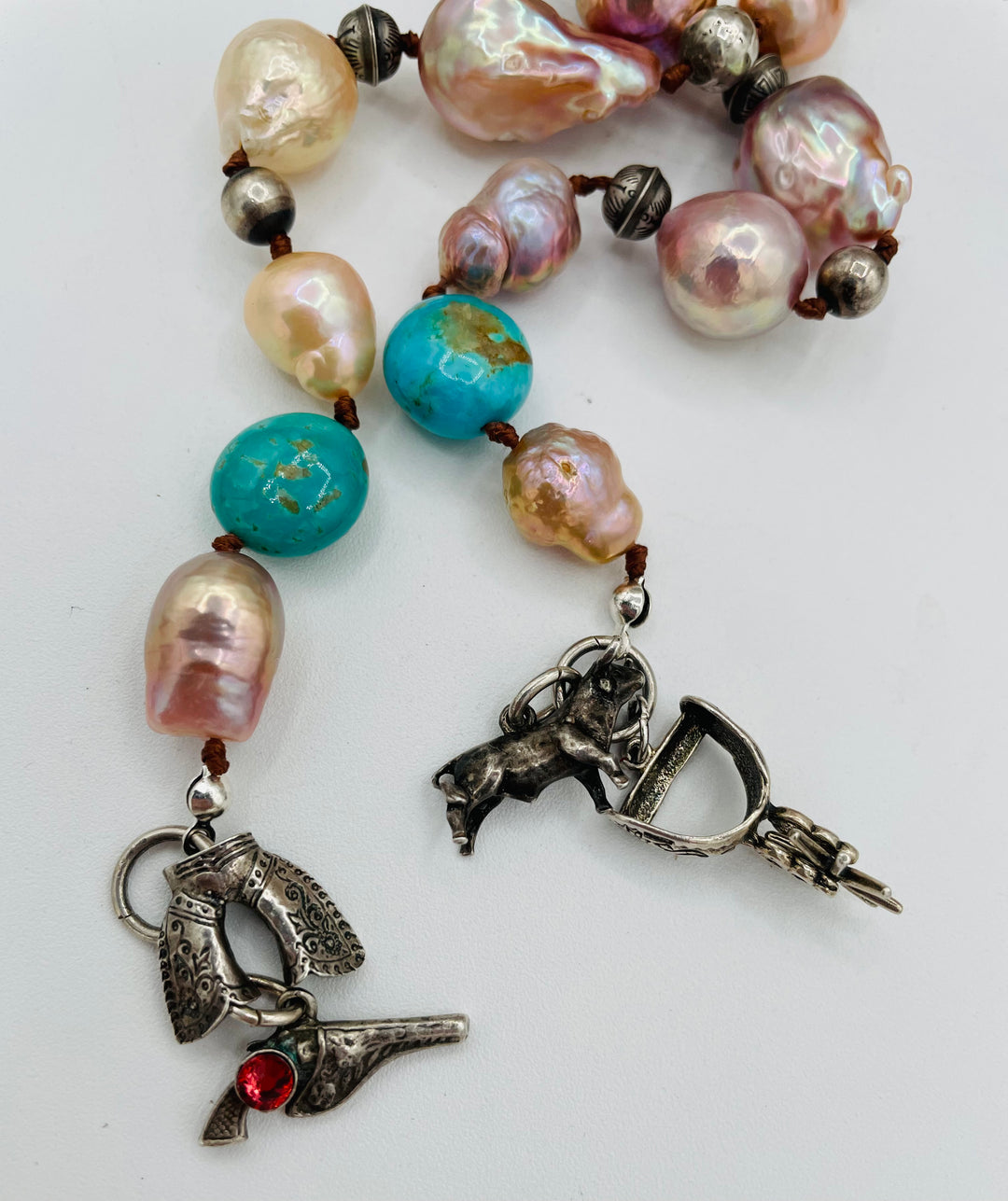 Silk knotted lariat necklace featuring baroque natural luster pearls, Kingman turquoise nuggets, and sterling silver beads. Available only from Rockstar Cowgirl online or in store in Cody, Wyoming.