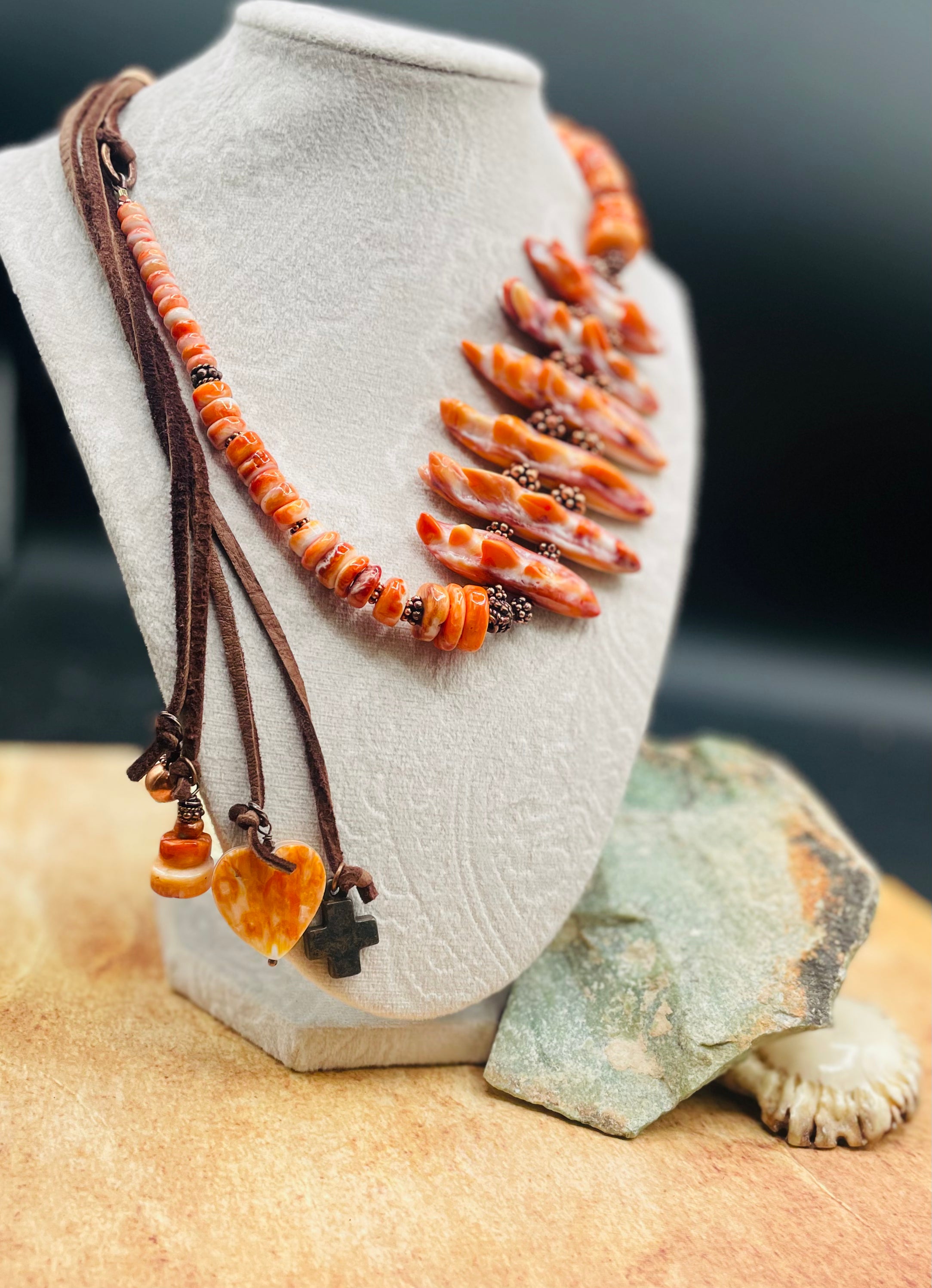 Hatband or necklace featuring several shapes of spiny oyster beads and copper accents. Finished with deer lace each with a charm and a slide bead for fit. Available only from Rockstar Cowgirl online or in store in Cody, Wyoming.