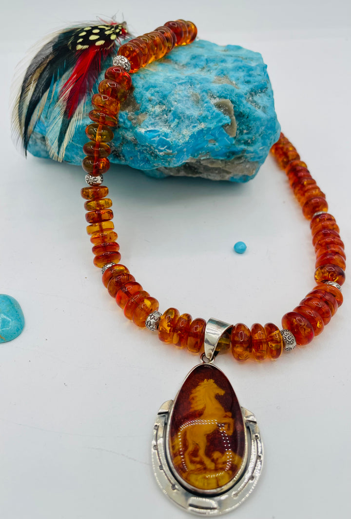 Beaded Baltic amber and sterling silver necklace featuring a Baltic amber and sterling silver pendent with a carved horse reverse cameo. Available only from Rockstar Cowgirl online or in store in Cody, Wyoming.